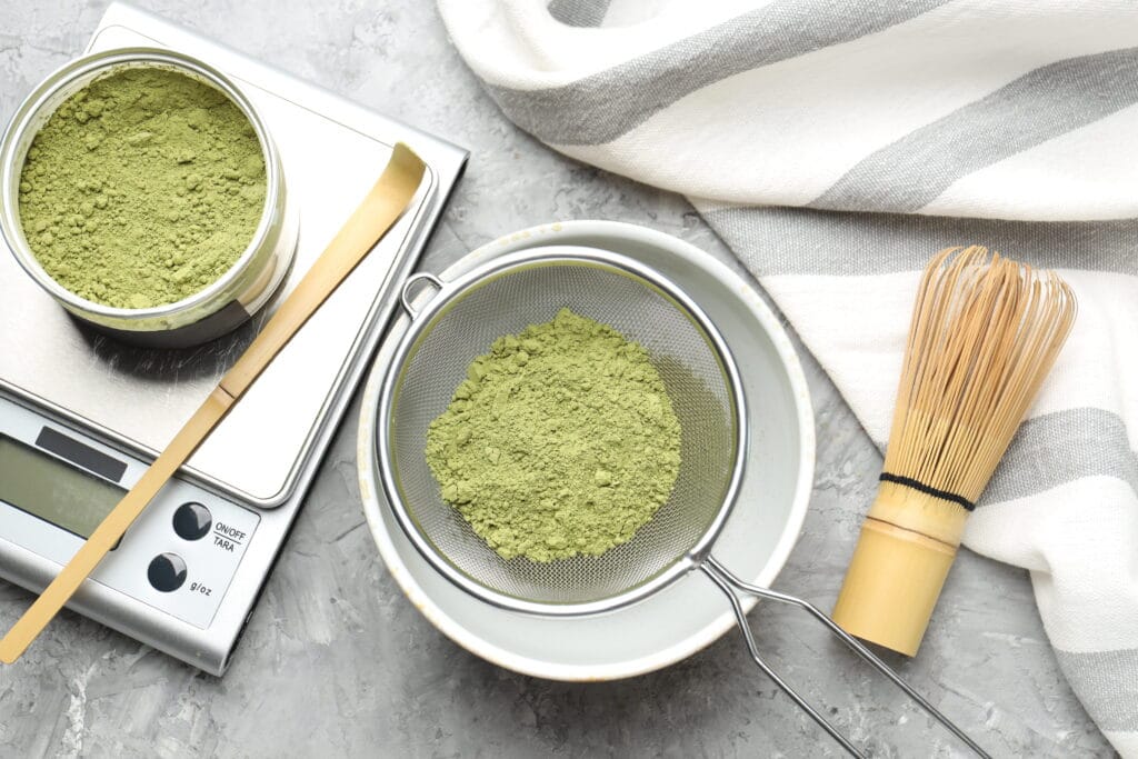 Overhead view of green powder and a traditional tea set