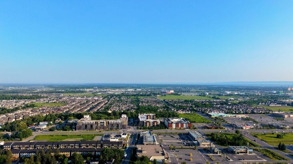 Aerial view of a Greater Toronto Area city spreading out under a bright blue sky