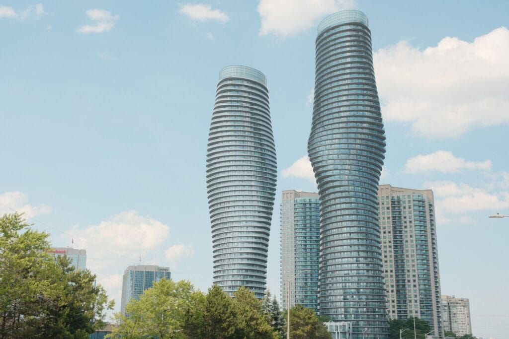 The curved Absolute towers rising above downtown Mississauga against a blue sky