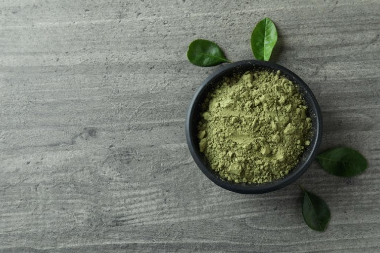 Fine green powder in a black bowl